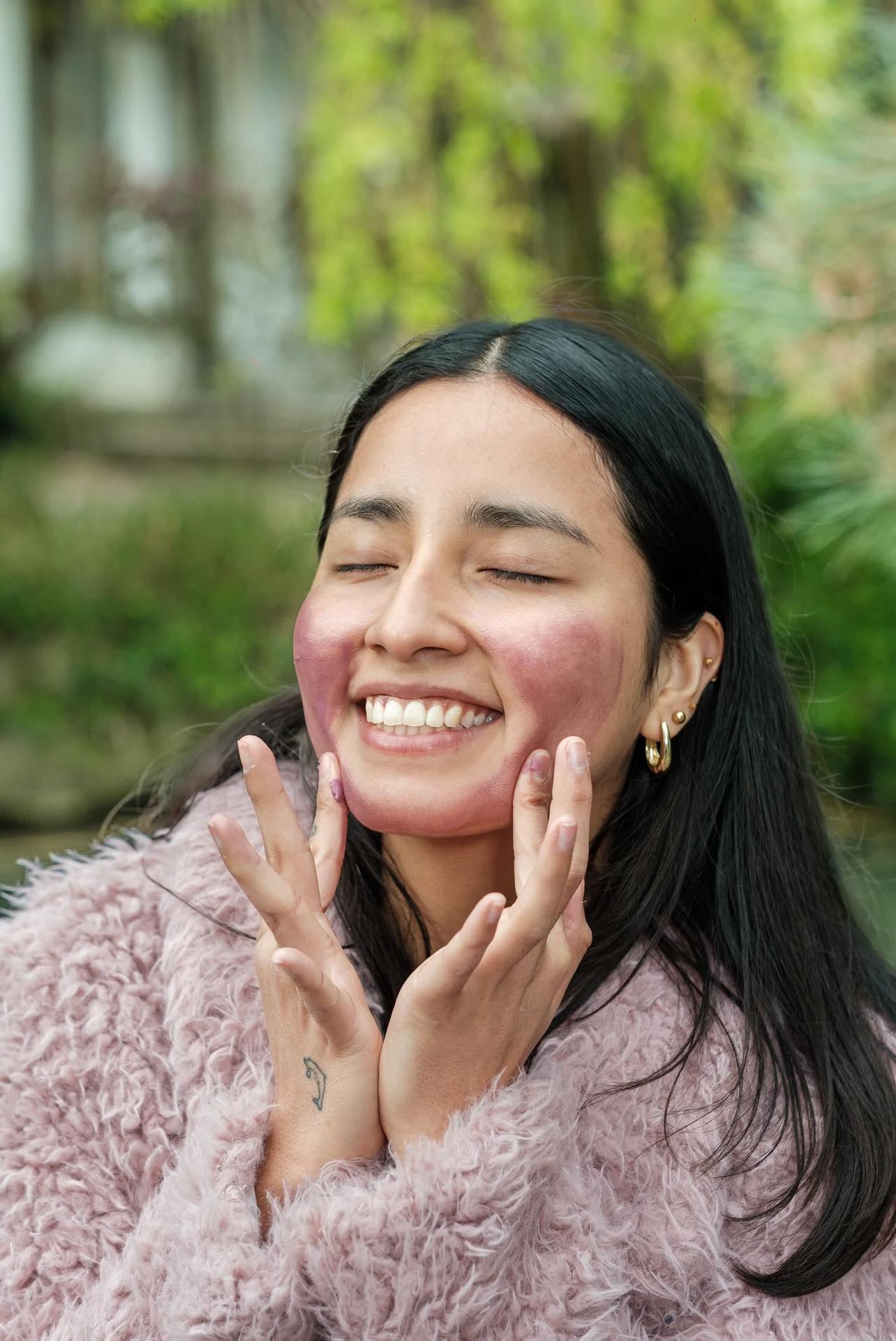 A girl using okoko skincare product