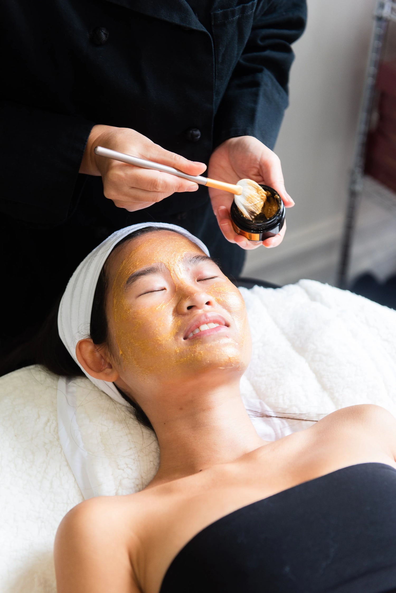 Maison OKOKO 24K gold sculpting facial in Vancouver designed to release jaw tension, de-puff the face, and restore radiant skin.